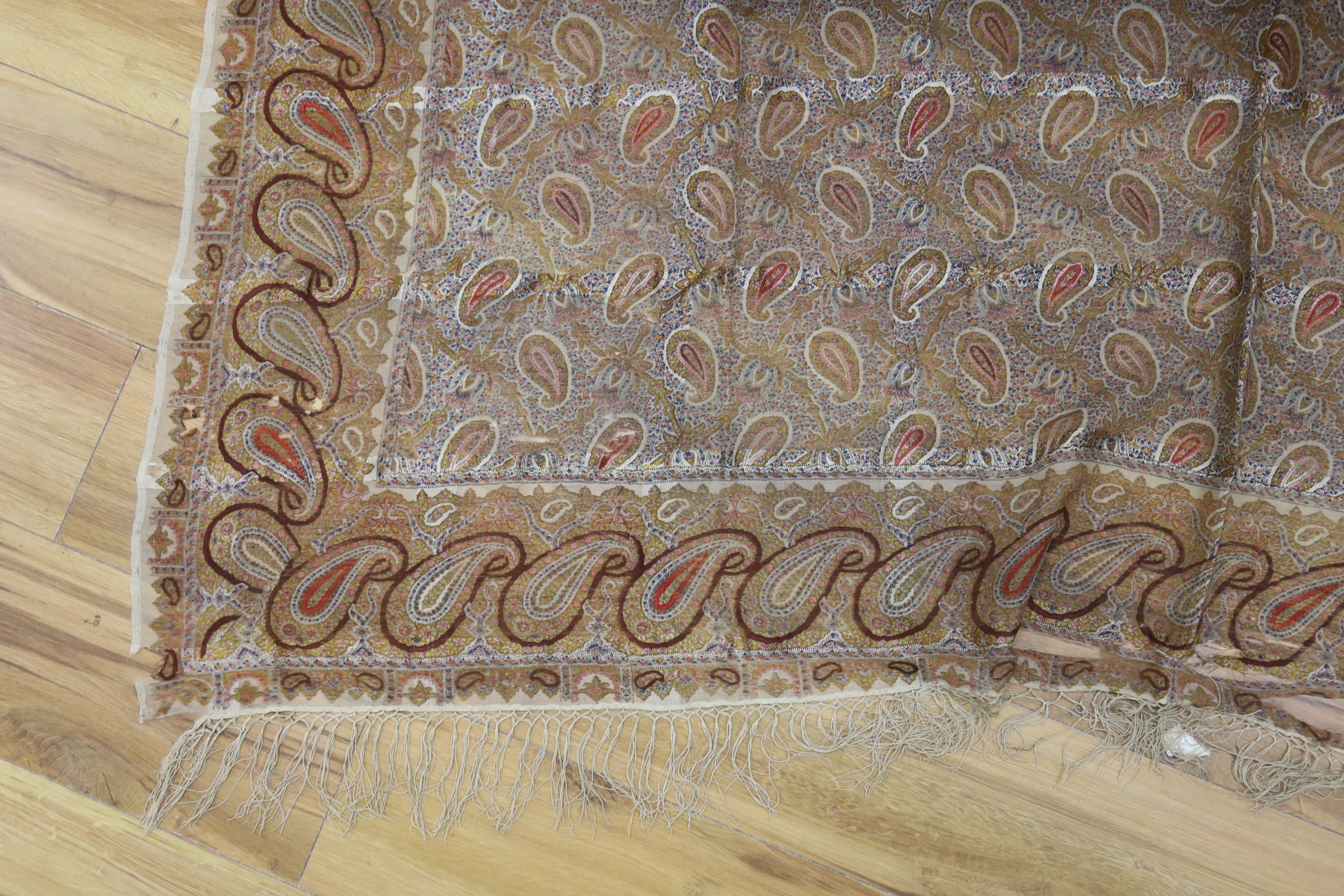 A Paisley pattern silk shaw (damaged) together with two Kelim woven bags (3)